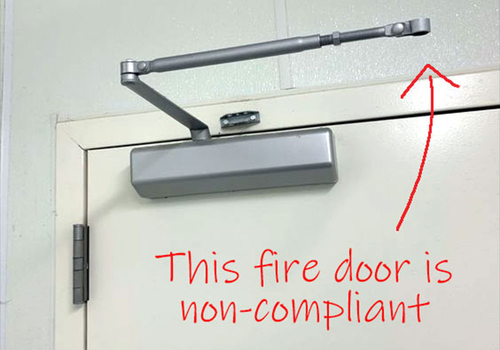 Disengaged fire door closer, not complying with fire door regulations