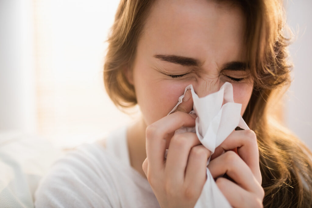 Woman blowing her nose