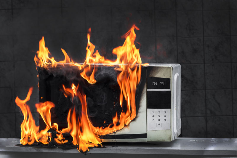 Microwave on fire, still powered on.