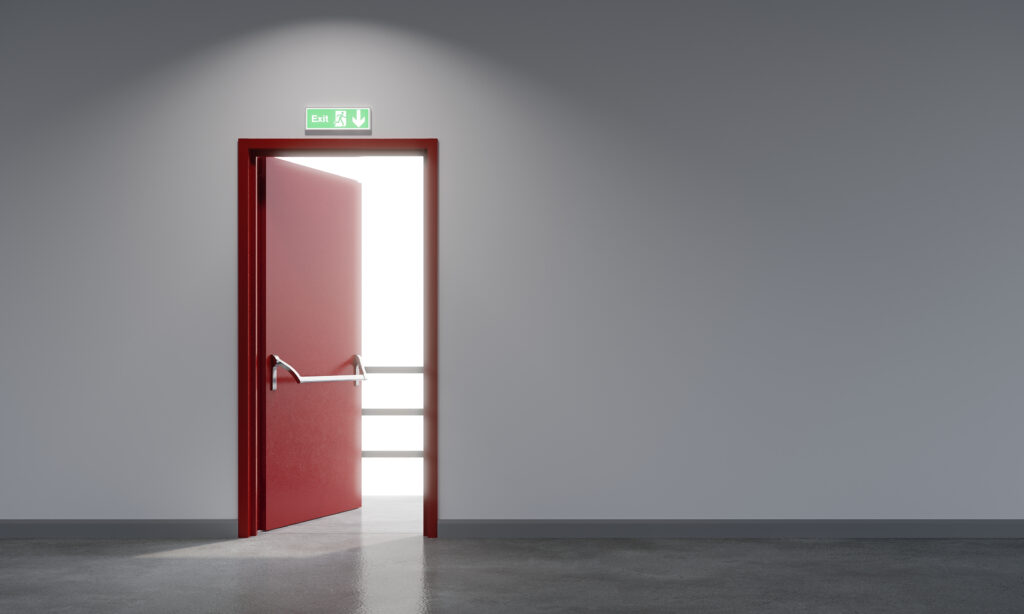 An open red fire door, leading to an external escape route.  