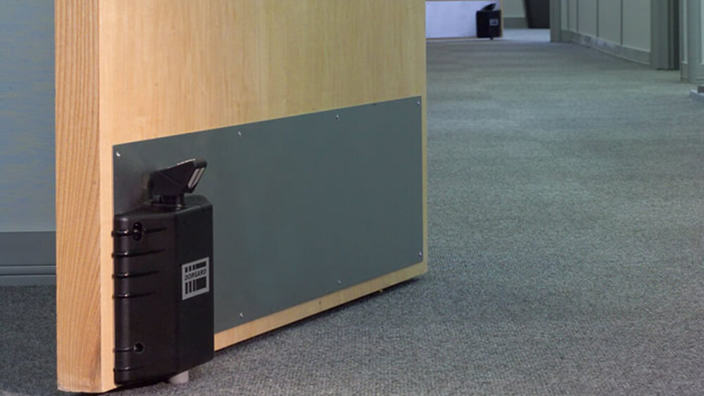 Dorgard fire door retainer on door