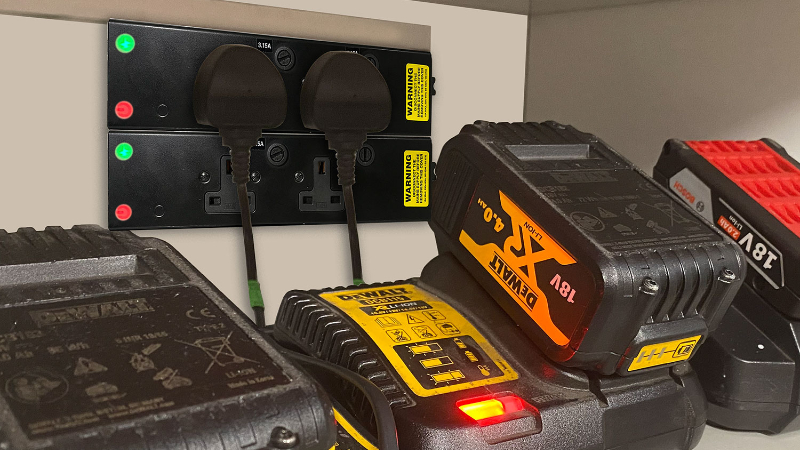 A bank of lithium-ion batteries charging in a specialist storage cabinet