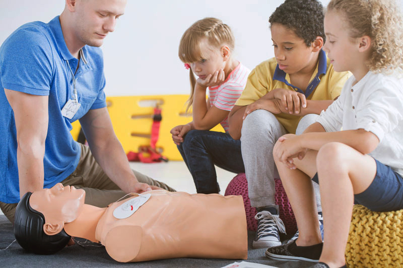 Defibrillator pads on a child manekin