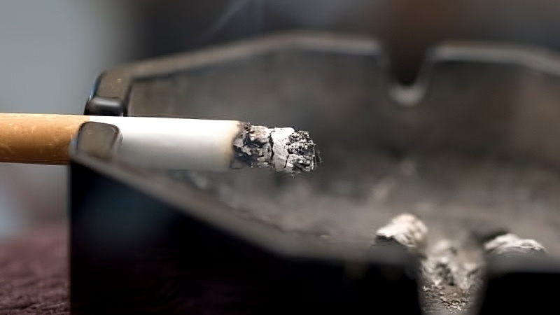 A burning cigarette in an ash tray