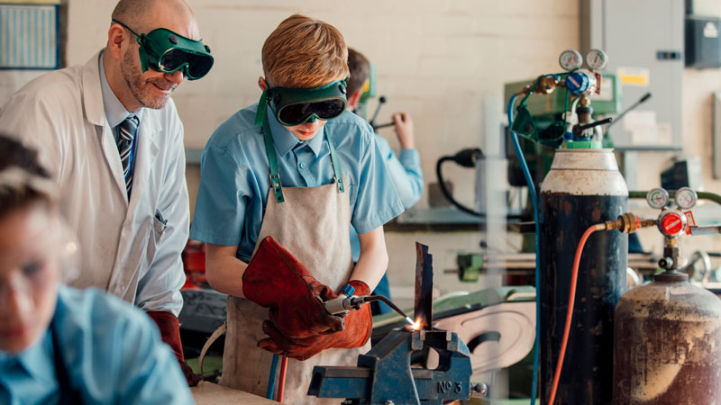 A school pupil using a welder