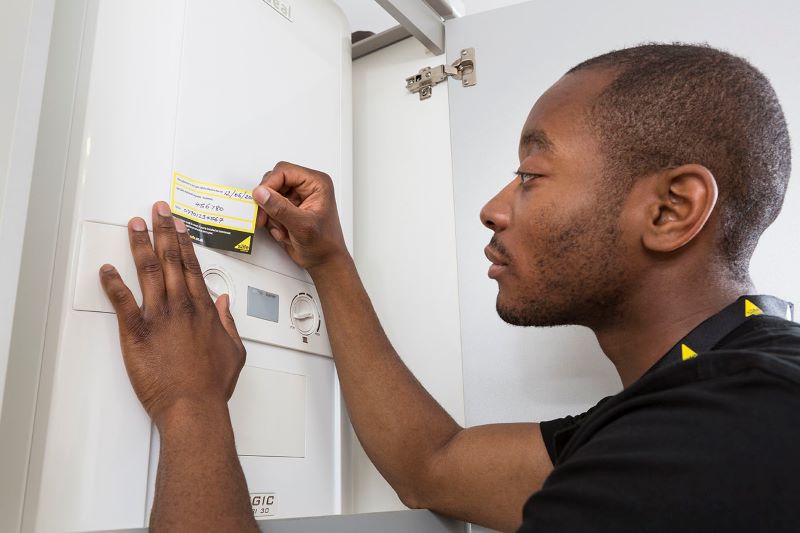 A Gas Safe engineer servicing a boiler