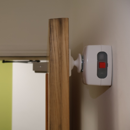 A magnetic fire door retainer