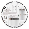 Back of a Kidde optical smoke alarm showing battery compartment, wiring points, printed specifications, and safety instructions.