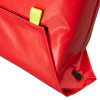 Close-up of a packed bag section of an emergency evacuation sledge showing red material and yellow strap detail