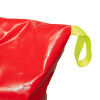 Close up of packed emergency evacuation sledge showing shiny red material and bright yellow strap loop