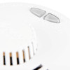 Close‑up of a Kidde smoke alarm featuring triangular HUSH and TEST WEEKLY buttons and vented sensor area.
