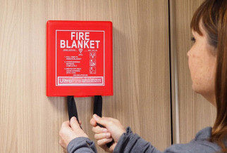A red fire blanket on a wall
