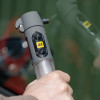 Hand holding aa emergency car torch window hammer belt cutter hammer against a car window in action