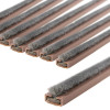 Close up view of a pack of brown double door fire and smoke seal strips with a soft grey brush edge