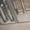 astroflame fire batt insulation installed between ceiling joists with metal ductwork and pipes visible
