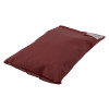 angled view of a large flat astro pillow in dark red fabric with a label on one corner