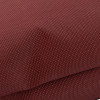 Close up of the stitching and textured fabric on the astro pillow large in a muted reddish-brown colour