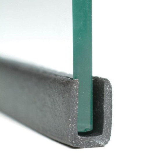 front view of intumescent glazing u channel holding a piece of glass against a white background