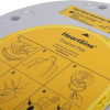 Close up of the Heartsine Samaritan Pad 350P Trainer Pak showing instructional illustrations on a yellow surface