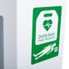 Green and white label showing a heart and person with the words Defibrillator Heart Restarter on a heartsine white internal cabinet
