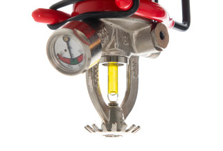 The head of an automatic fire extinguishers showing its pressure gauge