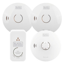 A set of four BLACK+DECKER fire safety devices, including two round smoke and one heat alarm and one rectangular control unit with labelled indicator lights and test/silence buttons.