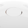 close up of the button on a black and decker connected smoke alarm in white plastic casing