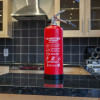 p50 2ltr water mist extinguisher standing on a kitchen island with cabinets and tiled splashback in the background