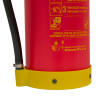 Close-up of the nozzle on a p50 wet chemical fire extinguisher with part of the red body and yellow base visible