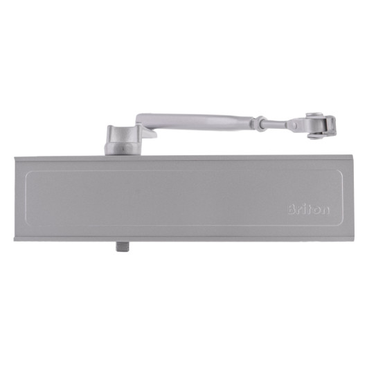 briton 1120b overhead door closer in silver shown from the front with arm extended