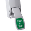 Closeup of the lever on a briton single door push pad latch with a green push to open label