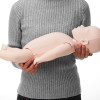 Close up of Brayden Baby In Mothers Arms showing the baby mannequin being held by a person in a grey sweater
