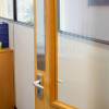briton 4700 plain radius plush plate 675mm mounted on the edge of a wooden door with a metal handle visible