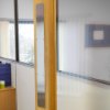 briton 4700 push plate 675 mounted vertically on a wooden door in an office setting
