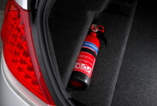 A red fire extinguisher in the boot of a car