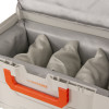 Open battery fire protection box showing grey padded sections inside with orange handle