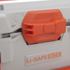 Close-up of an orange clip on a battery fire protection box showing locking mechanism and label