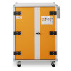 A rectangular metal cabinet with an orange front, black hinges, a central locking handle, and safety labels on the upper right.