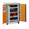 An open metal cabinet with orange doors containing multiple shelves of STIHL‑branded power tool batteries and chargers plugged into internal sockets.