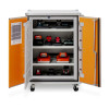 A wheeled cabinet with open orange doors showing organised shelves of STIHL batteries and chargers, with a safety sheet on the left door.