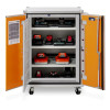 Open cabinet with three shelves of STIHL and mixed‑brand battery chargers, each plugged in for organised charging