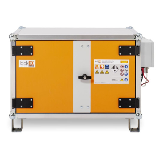Bright orange industrial safety cabinet with a central grey strip and warning labels indicating suitability for lithium battery storage.
