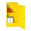 A yellow single‑door flammable liquid storage cabinet shown open, with two internal shelves holding red bottles on the top shelf and white metal containers on the lower shelf.