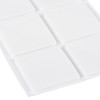 Close‑up view of white square adhesive pads on a backing sheet