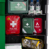 closeup of the open ultrafire green weatherproof first aid cabinet showing various first aid kits and supplies inside