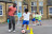 School children playing football outdoors with a male coach supervising, related to Defibrillators For Schools