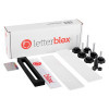 Contents of letterblox letterbox blanking plates including white plates, black frame, screws, washers, and a sticker sheet
