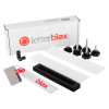 letterblox letterbox blanking plates kit showing white plates, black rectangular frame, fixing screws, and packaging box