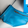 part of de raat protector mp3 deposit safe key lock shown as a blue collection bag with a zip on a table surface