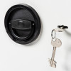Key angled next to a black lock handle on a de raat protector mp3 deposit safe key lock
